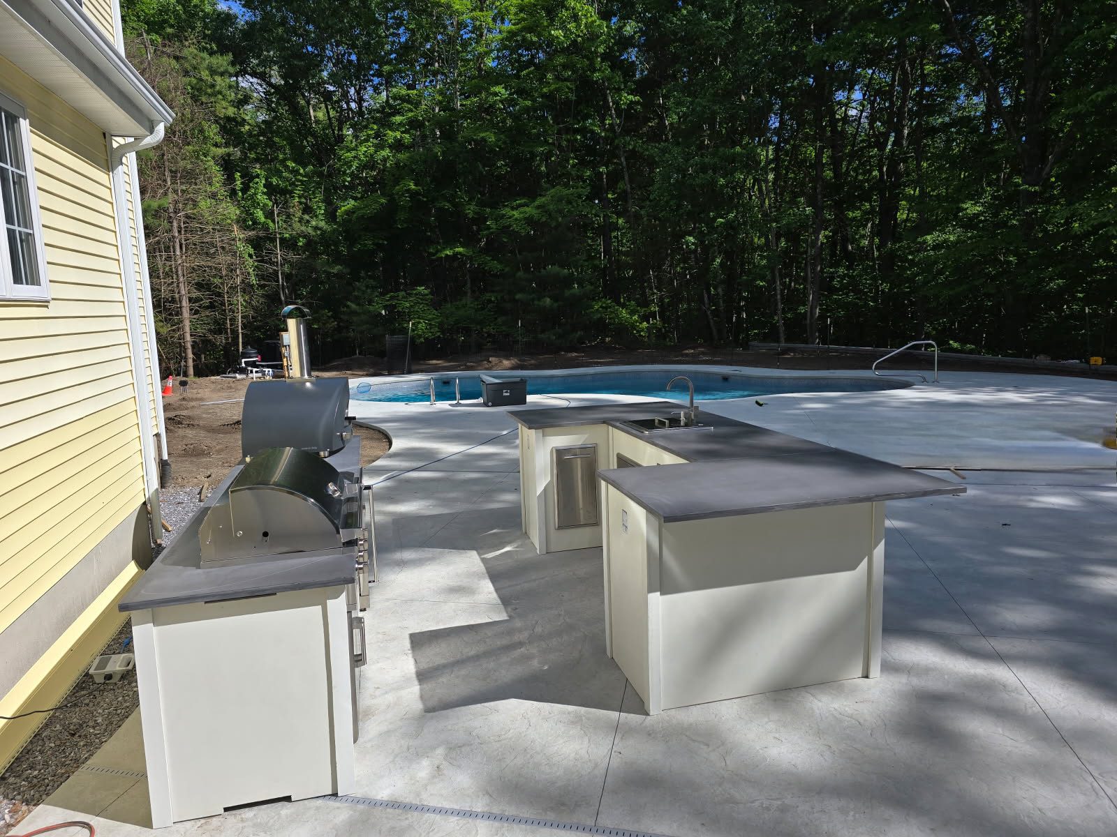 67fd74e6c7f8a_IMG_20250409_133347 A white outdoor kitchen with an oven and sink.