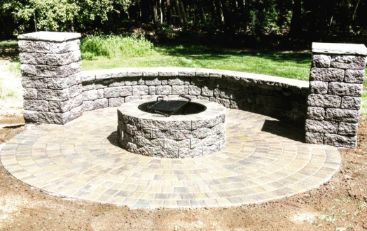 A fire pit sitting in the middle of a patio.
