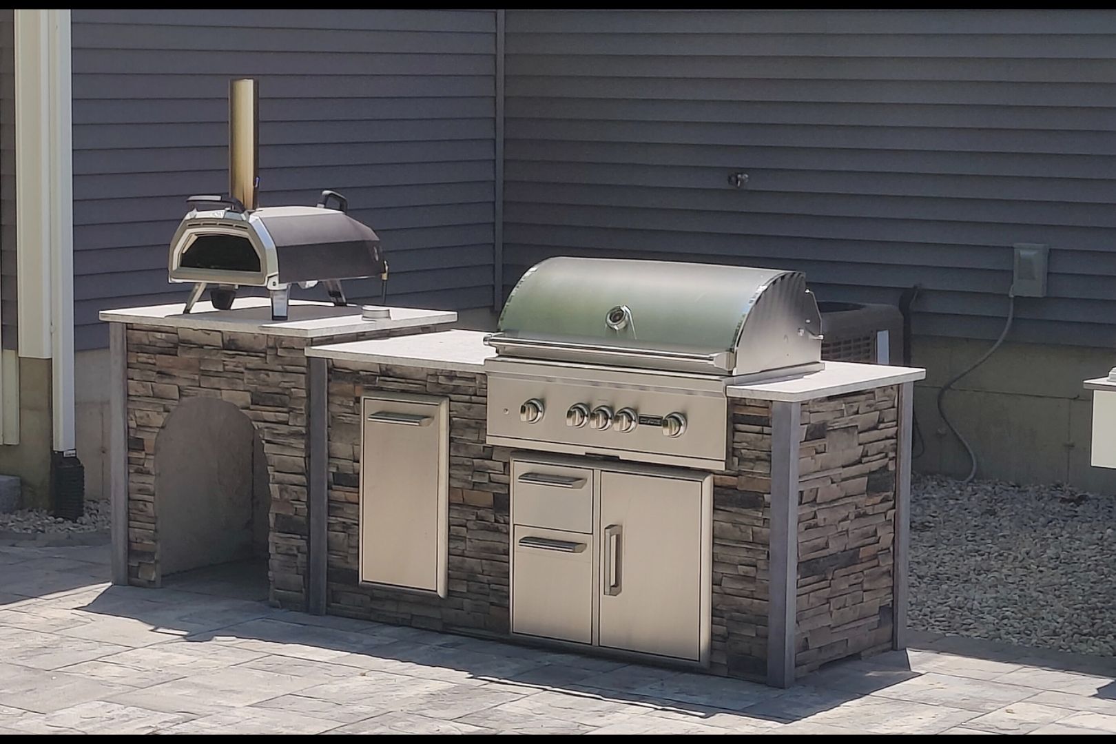 68026f8be4989_Screenshot_20250411_125541_Gallery(1) (1) A grill and oven outside on the patio.