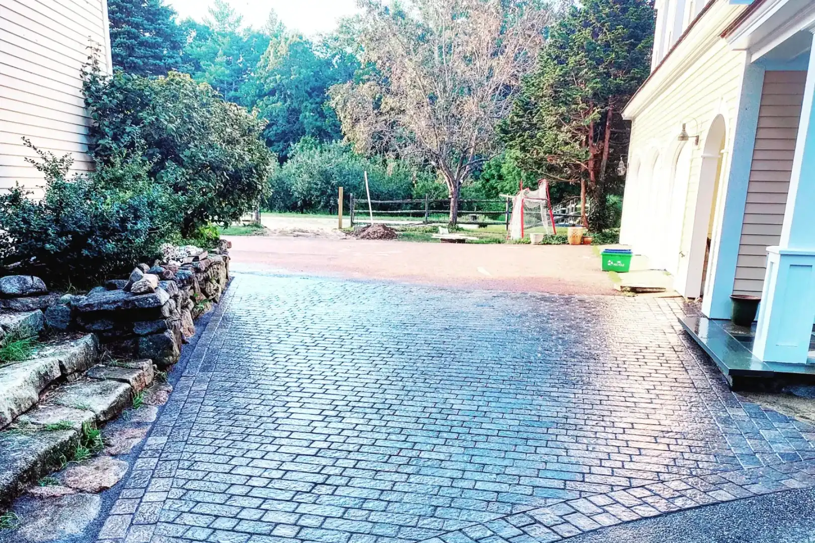 68026f8c489c8_IMG_20210831_075902_367 (1) A driveway with brick and stone pavers in the middle of it.