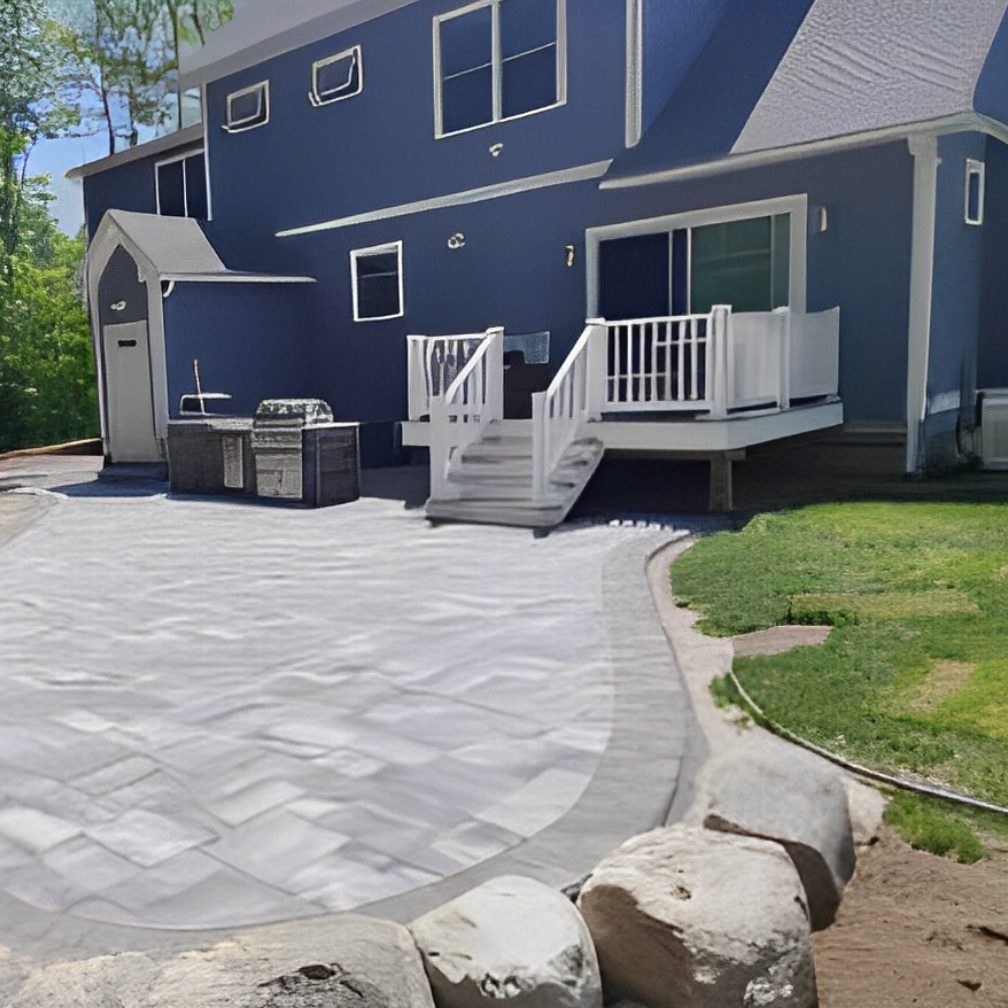 A patio with steps leading to the back of the house.